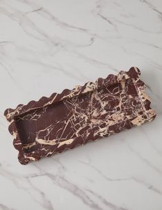 a piece of chocolate sitting on top of a marble counter