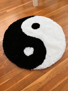 a black and white rug sitting on top of a wooden floor