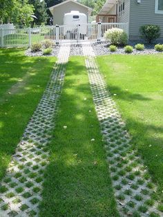 a yard with grass and stepping stones in the middle