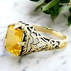 Elevate your jewelry collection with our stunning Vintage Natural Citrine Solitaire Filigree Ring, a true masterpiece crafted from 925 Solid Sterling Silver. This alluring piece features a mesmerizing 9x7 mm natural citrine stone, renowned for its warm, golden hues that radiate positivity and joy. The ring's intricate filigree design adds a touch of vintage elegance, making it perfect for both everyday wear and special occasions. With a top measurement of 7/16 inches, this ring delicately adorns your finger while making a bold statement! Each detail of this exquisite ring is a testament to its handcrafted quality. With a secure setting and a stamped 925 mark, you can trust in the authenticity and durability of this beautiful piece. Whether you're treating yourself or searching for that spe Classic Citrine Rings With Accent Stones, Classic Citrine Gemstone Ring, Classic Citrine Rings For Formal Occasions, Elegant Yellow Sapphire Sterling Silver Ring, Yellow Sapphire Ring With Accent Stones, Elegant Yellow Sapphire Ring For Gift, Elegant Yellow Sapphire Gift Ring, Classic Formal Citrine Rings, Elegant Yellow Sapphire Ring As Gift