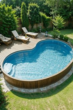 an above ground swimming pool surrounded by lawn furniture and landscaping area with wooden decking