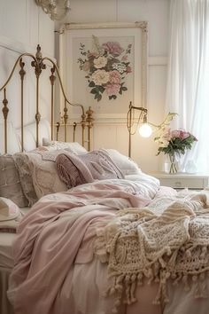 a white bed with pink sheets and pillows