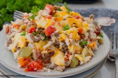 a close up of a plate of food with rice and veggies on it