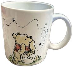 a winnie the pooh coffee mug with an image of a teddy bear on it