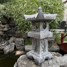 a stone lantern sitting on top of a rock