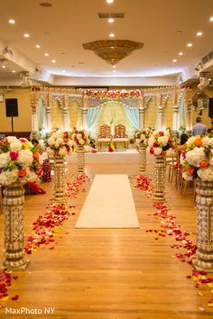 the aisle is decorated with flowers and petals