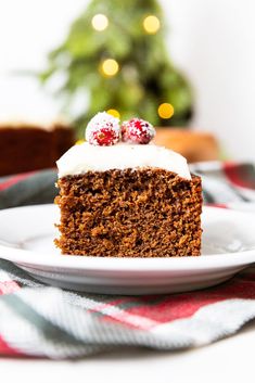 a slice of cake on a plate with a christmas tree in the backgroud