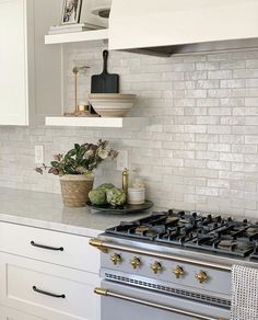 a stove top oven sitting inside of a kitchen next to a white cupboards and counter