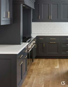 an empty kitchen with black cabinets and white counter tops is pictured in this image from the front view