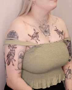 a woman with tattoos on her chest and arms