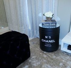 a black trash can sitting on top of a carpeted floor