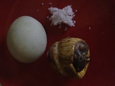 an egg and shell on a red plate