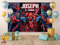 spiderman birthday party backdrop with balloons and presents in front of the wall that says joseph is turning 7