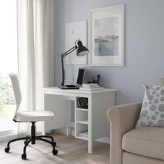 a white desk and chair in a room