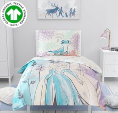 a bed with an image of the princess and frog on it in a white room