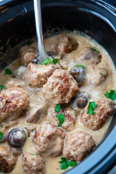 a crock pot filled with meatballs and gravy