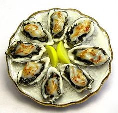 a white plate topped with oysters covered in sauce