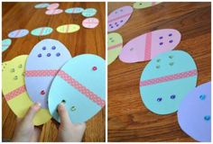 some paper easter eggs on a wooden table