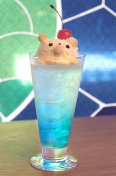 an ice cream sundae in a tall glass with a cherry on top and two teddy bears sticking out of it