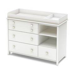 a white baby crib with drawers and changing table in the front view on a white background