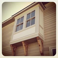 an apartment building with two windows on the side