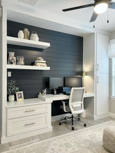 a home office with blue painted walls and white furniture, along with a ceiling fan