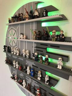 star wars legos are arranged on shelves in the shape of a wall mounted clock