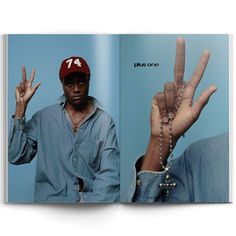 an open book with a man wearing a red hat and beaded bracelets on his fingers