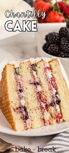 a slice of cake on a white plate with berries and blackberries in the background