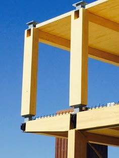 an airplane is flying over the top of a wooden structure with railings on both sides