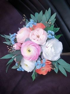 a bouquet of flowers sitting on top of a car seat