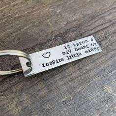 a keychain that says, it takes a big heart to inspire little minds