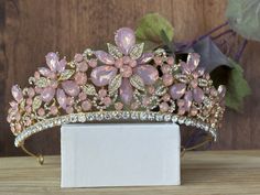 Beautiful, sparkles, good quality Tiara with Big Opal Pink Stones and Crystal Rhinestone set on the Tiara. Perfect for Prom, Birthday, Sweet 16, Quinceanera, Anniversary, Wedding, or for any other special occasion. Or just to be THE QUEEN. THE COLORS ON THE TIARA: Gold the tiara frame, Opal Pink and Crystal clear Rhinestone. THE SIZE 2" tall on the front. 1" tall on the sides. GIFT BOX IT'S NOT INCLUDED! This item it will send on STANDARD FIRST CLASS MAIL (2 to 5 business days). in USA If you ne Pink Tiara, Birthday Sweet 16, Quinceanera Tiaras, Tiara Gold, Prom Birthday, Gold Tiara, Tiara Wedding, Pink Stones, Wedding Pink