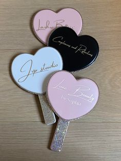 three heart shaped lollipops with names on them