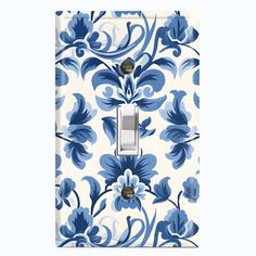 a blue and white flowered light switch cover with a floral design on the front