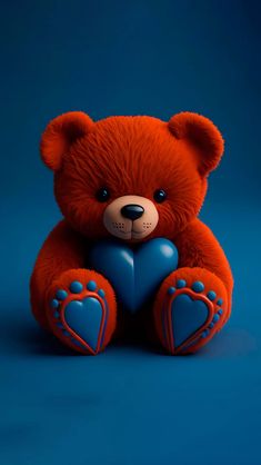 a red teddy bear holding a blue heart on a blue background with space for text