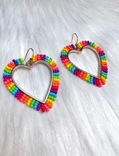 These awesome pride heart earrings are part of our new Valentine's Day Collection. It's packed full of beautiful pieces.  These beaded earrings are made with a vibrant rainbow pattern. The centers are gold hearts and the hooks are also gold. Pride Earrings Beaded, Pride 2023, Beaded Rainbow, Pride Earrings, Pride Heart, Beadwork Earrings, Native Beadwork, Gold Hearts, Rainbow Earrings