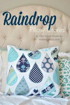 a bed with pillows on top of it and the words raindrop pillow tutor written in blue