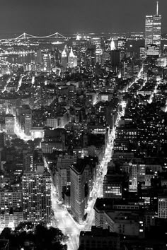 an aerial view of the city at night from above, looking down on skyscrapers