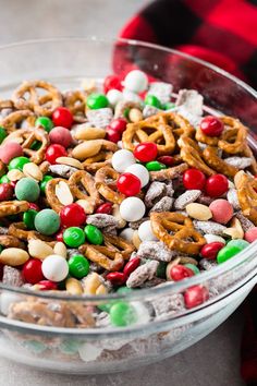 a glass bowl filled with candy and pretzels