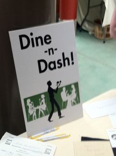 a sign that says dine n'dash on it next to papers and pens