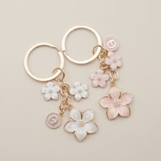 three key chains with flowers on them