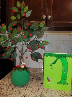 a potted plant sitting on top of a kitchen counter next to a green box