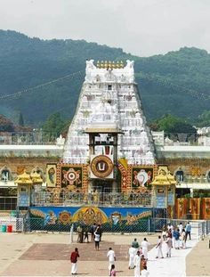 people are walking around in front of a temple