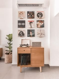 a record player sitting on top of a wooden cabinet