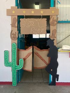 an entrance to a restaurant with cactus decorations