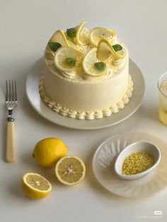 there is a cake with lemons on the top and other food items around it