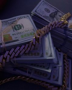 stacks of money are wrapped in purple and gold