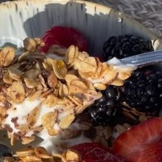 a bowl filled with granola, berries and yogurt