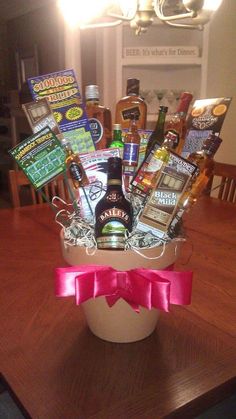 a gift basket with alcohol and snacks on a table